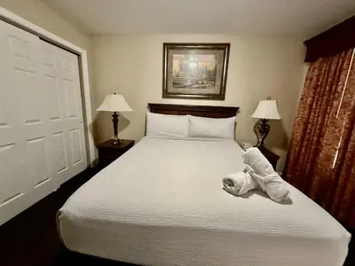 a bedroom with a large white bed with two lamps at Entire Condo - 3Bed 2Bath- 5 mins to Disney Park in Orlando