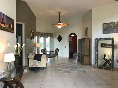 a living room with a couch and a table at Formosa Villa with Private Pool & 5 Miles to Disney in Orlando
