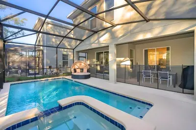 a swimming pool in a house with a glass ceiling at Luxo com 6 Quartos e Piscina! – Storey Lake in Kissimmee
