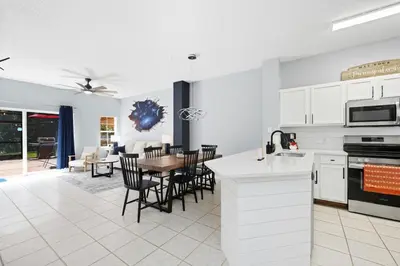 a kitchen and living room with a table and chairs at Private Hot Tub Terra Verde Resort Pool Themed Rooms in Kissimmee