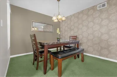 a dining room with a table and two chairs at Great for Families 1-4 Kids! Near Disney, Universal, Shopping, Dining in Kissimmee