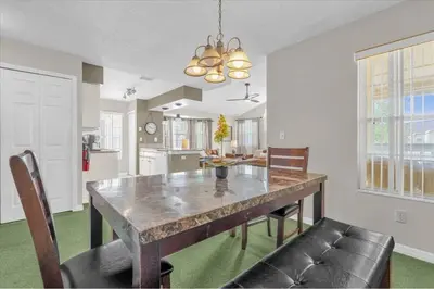 a kitchen and dining room with a table and chairs at Great for Families 1-4 Kids! Near Disney, Universal, Shopping, Dining in Kissimmee