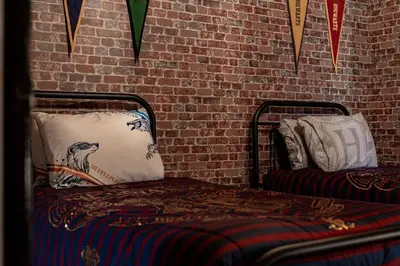 a bedroom with a bed and a brick wall at 5 Mi to Disney 4 Master Bed Rooms and Themed in Orlando