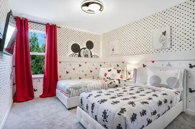 a bedroom with two beds and a window with red curtains at 5 Mi to Disney 4 Master Bed Rooms and Themed in Orlando
