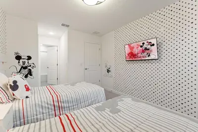 a bedroom with a mickey mouse pillow on a bed at 5 Mi to Disney 4 Master Bed Rooms and Themed in Orlando