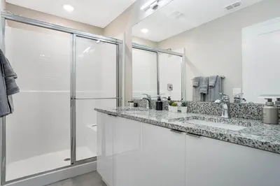 a bathroom with two sinks and a shower at 5 Mi to Disney 4 Master Bed Rooms and Themed in Orlando