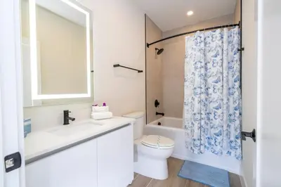 a white bathroom with a sink and a toilet at Stylish Property with Private Pool in Orlando