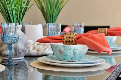 a table with plates and a bowl with a napkin at Windsor Hills Family Paradise in Orlando
