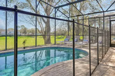 a swimming pool with a fence around it at Windsor Hills Family Paradise in Orlando