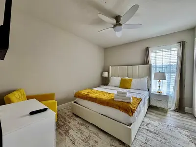 a bedroom with a bed and a ceiling fan at Modern 4BR 2BA with pool in gated community in Kissimmee