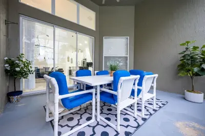 a dining room with a white table and blue chairs at Luxury Disney Retreat in Kissimmee