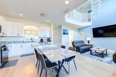a kitchen and living room with a table and chairs at EIR2706 - 7B Lakefront Resort 8 min to Disney in Kissimmee