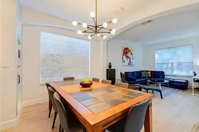 a dining room and living room with a table and chairs at EIR2706 - 7B Lakefront Resort 8 min to Disney in Kissimmee