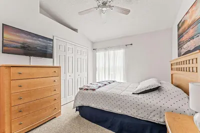 a bedroom with a bed and a dresser and a window at Magical Family Getaway - 10ppl in Kissimmee