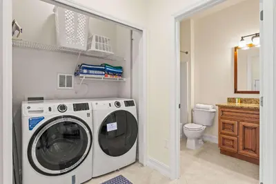 a washing machine in a bathroom with a toilet at Palm Tree in Paradise - 10ppl in Kissimmee