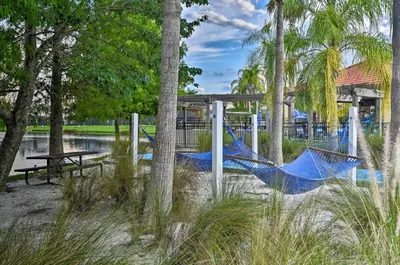 a blue hammock in a park with a picnic table at Palm Tree in Paradise - 10ppl in Kissimmee