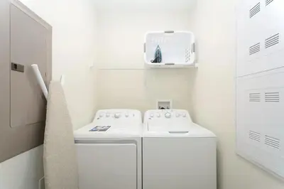 a small white laundry room with a washer and dryer at Casa Espaçosa + Piscina Privada + Resort TOP in Kissimmee