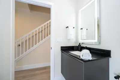 a bathroom with a sink and a mirror at Modern 3Bd Screened Pool at Serenity Resort 17322 in Orlando