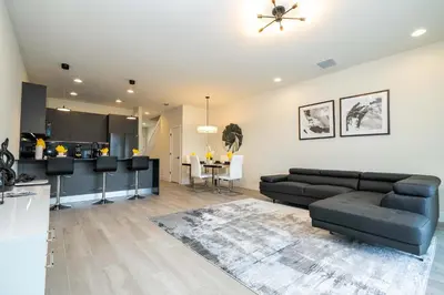 a living room with a couch and a kitchen at Modern 3Bd Screened Pool at Serenity Resort 17322 in Orlando