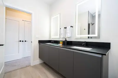 a bathroom with a black sink and a mirror at Modern 3Bd Screened Pool at Serenity Resort 17322 in Orlando