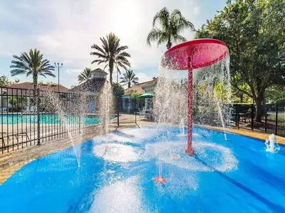 a fountain in the middle of a swimming pool at WP8167SPD – Spacious 6-Bed Oasis with Pool near Disney in Kissimmee