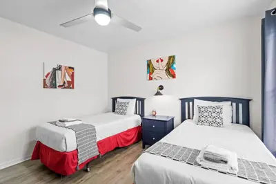a bedroom with two beds and a ceiling fan at 3 Bedroom 2 Bathroom Villas At Seven Dwarfs 25-105 in Kissimmee