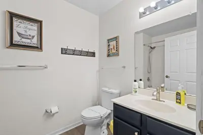 a bathroom with a sink and a toilet and a mirror at 3 Bedroom 2 Bathroom Villas At Seven Dwarfs 25-105 in Kissimmee