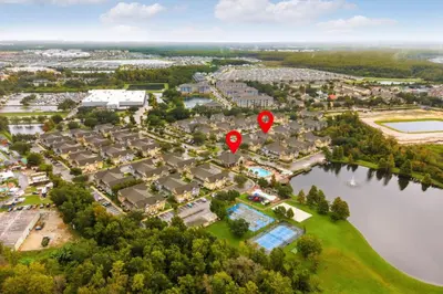 an aerial view of a town with a red marker at 3 Bedroom 2 Bathroom Villas At Seven Dwarfs 25-105 in Kissimmee