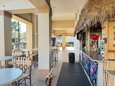 a restaurant with tables and chairs and a bar at 3 Bedroom 2 Bathroom Villas At Seven Dwarfs 25-105 in Kissimmee