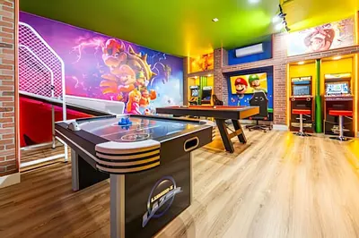a ping pong room with a ping pong table and a video game at Windsor Hills 4Q c Piscina + Game Room Mario in Orlando