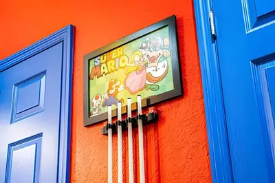 a sign on the side of a building with a tv at Windsor Hills 4Q c Piscina + Game Room Mario in Orlando