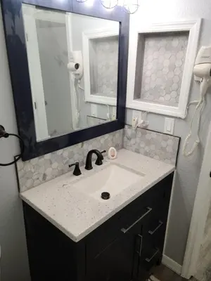 a bathroom with a sink and a mirror at Great condo getaway! in Kissimmee