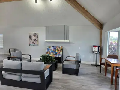 a living room with a couch and chairs and a table at Great condo getaway! in Kissimmee
