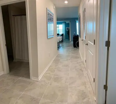 a hallway with a tile floor in a house at To Infinity and Beyond – Storey Lake Resort by Shine Villas condo in Kissimmee