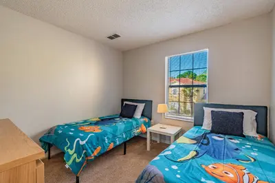 a bedroom with two beds and a window at Private Hot Tub near Disney Parks in Kissimmee