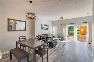 a dining room and living room with a table and chairs at Private Hot Tub near Disney Parks in Kissimmee