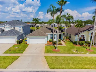 a residential neighborhood with houses and palm trees at Private Heated Pool near Disney in Kissimmee