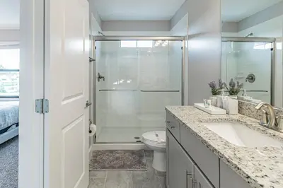 a bathroom with a shower and a toilet and a sink at Themed Bedrooms BBQ Near Disney in Kissimmee