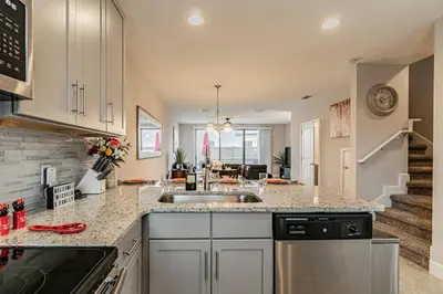 a kitchen with a sink and a counter top at Themed Bedrooms BBQ Near Disney in Kissimmee
