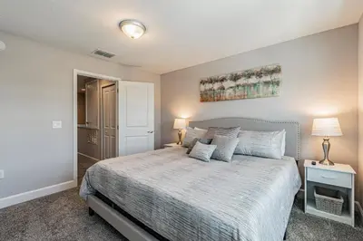 a bedroom with a bed with a white bedspread at Themed Bedrooms BBQ Near Disney in Kissimmee
