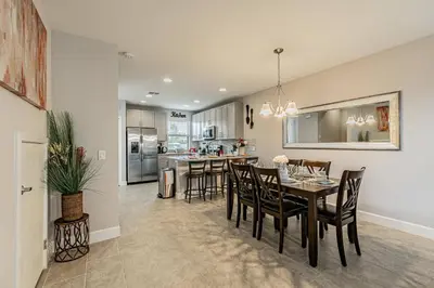 a dining room and kitchen with a table and chairs at Themed Bedrooms BBQ Near Disney in Kissimmee
