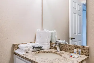 a bathroom counter with a sink and a mirror at Family Home Near Disney – Modern Bright in Kissimmee