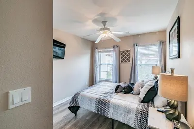 a bedroom with a bed and a window at Family Home Near Disney – Modern Bright in Kissimmee