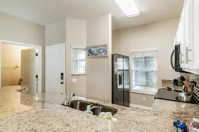 a kitchen with a sink and a counter top at Family Home Near Disney – Modern Bright in Kissimmee