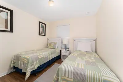 two beds in a room with white walls at Family Villa w Pool · 20min Disney in Kissimmee