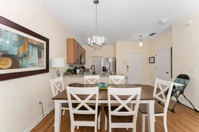 a dining room and kitchen with a table and chairs at Family Villa w Pool · 20min Disney in Kissimmee