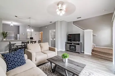 a living room with a couch and a table at Cozy 3BR Townhome Near Disney in Kissimmee in Kissimmee