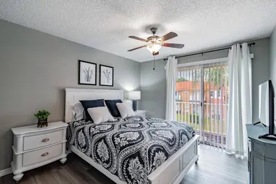 a bedroom with a bed and a ceiling fan at Cozy 3BR Townhome Near Disney in Kissimmee in Kissimmee
