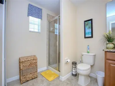 a bathroom with a shower and a toilet at Cozy 3BR Villa 15min from Disney Heated Pool in Kissimmee