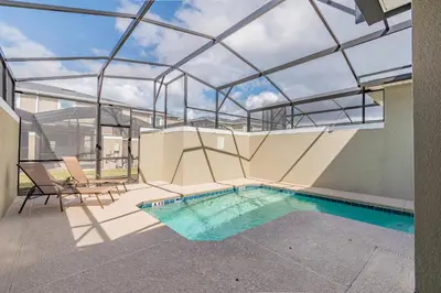 an indoor swimming pool with a glass ceiling at Disney 15min - Private Pool BBQ in Kissimmee